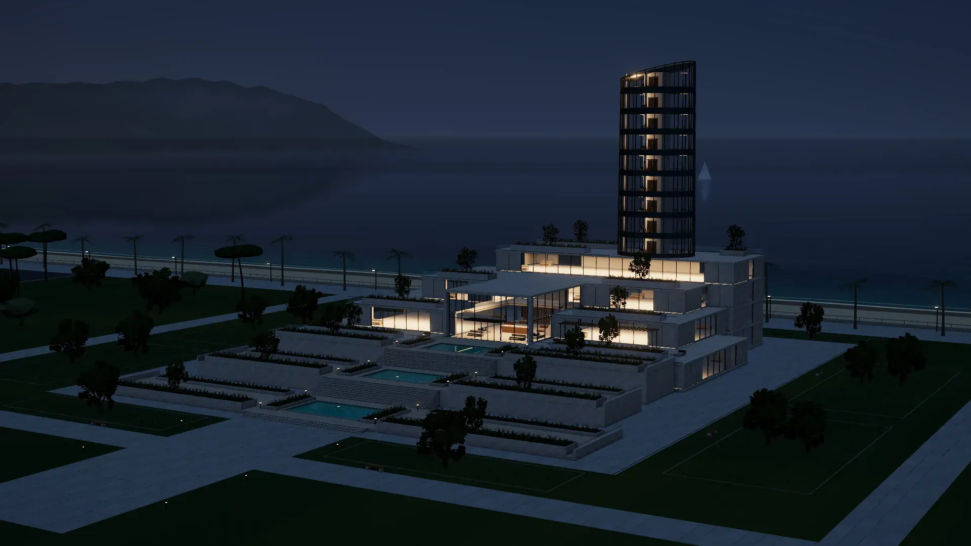 Edificio de ejemplo junto al mar al anochecer, con la torre y las terrazas iluminadas